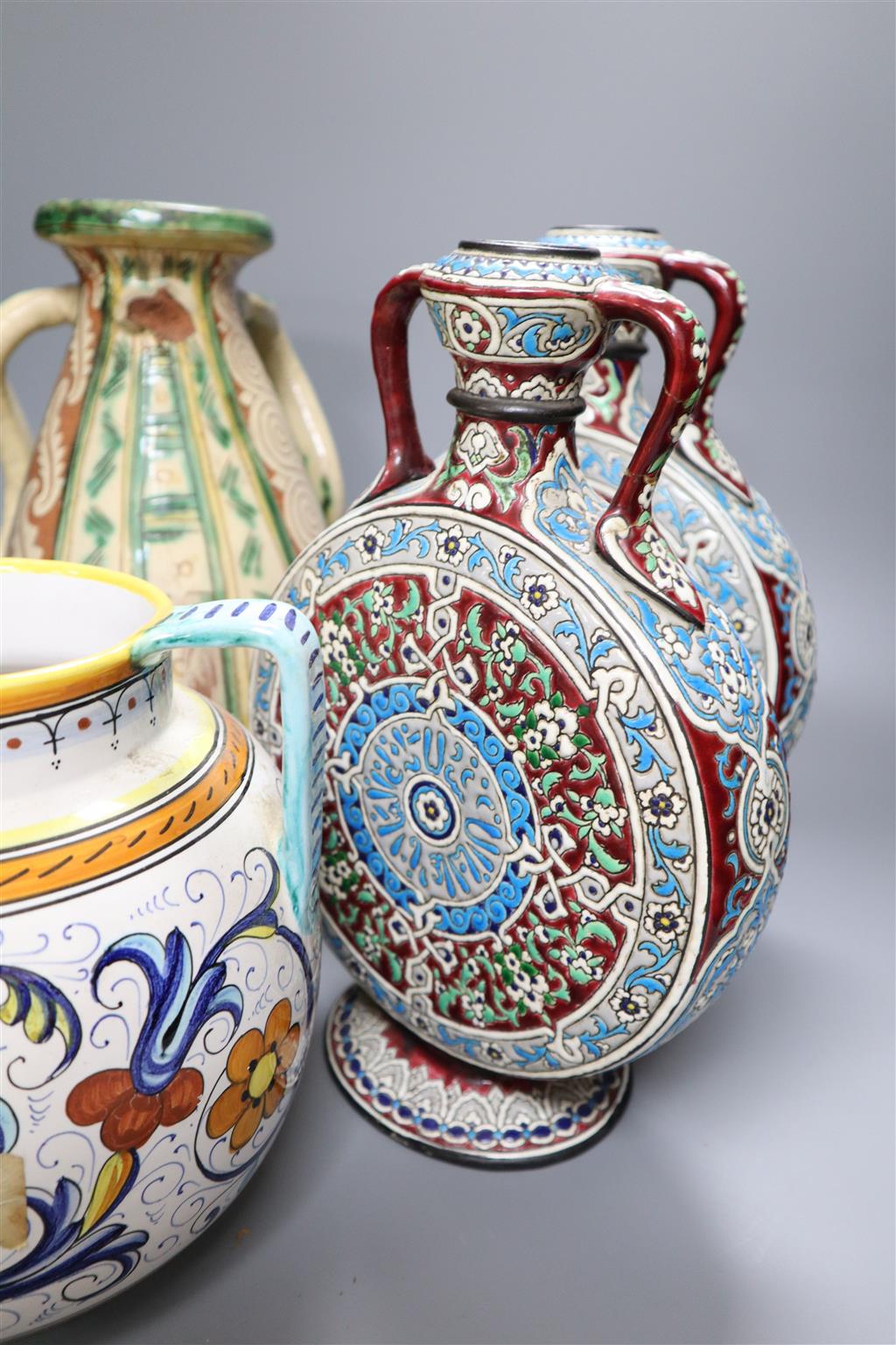 A pair of Isnik inspired pottery moon flasks, 30cm and an Italian pottery vase and another